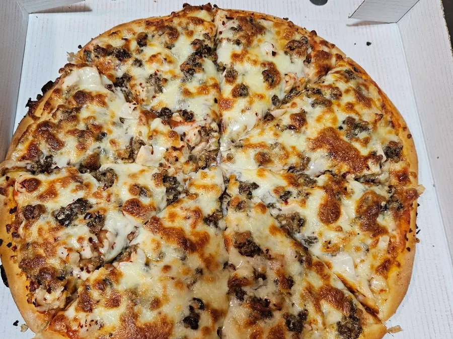 Meat feast pizza in its box